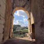 A pretty shot of Rome through an ancient arch of the Colosseum.