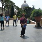 Toni on the terrace of the Vatican Museum with the dome of St. Peter's.