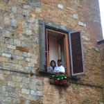 Ryan and Emily in the hotel window overlooking the Piazza Cisterna in San Gimignano.  The same one they overslept in.