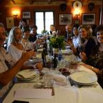 Everyone enjoying a delicious meal and wine tasting.