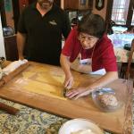 Mama shows everyone how to cut the pasta for tortellini.
