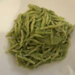 Homemade trofie pasta with fresh basil pesto.